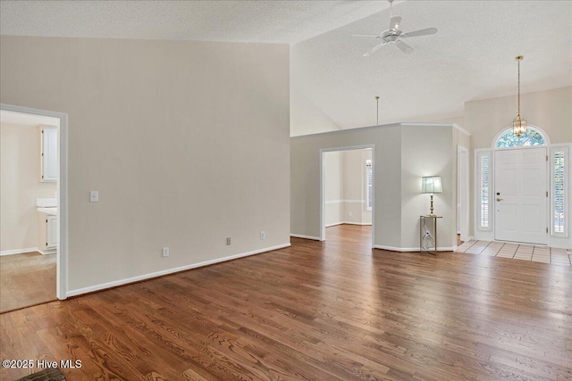 6 Elmhurst Pl, Pinehurst, NC 28374 - unfurnished living room with high vaulted ceiling, wood finished floors, a ceiling fan, and a textured ceiling