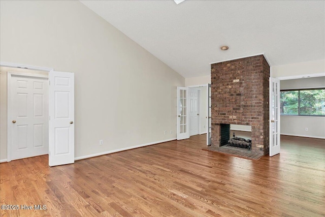 6 Elmhurst Pl, Pinehurst, NC 28374 - unfurnished living room featuring wood finished floors, high vaulted ceiling, and a fireplace