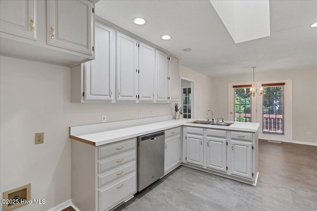 6 Elmhurst Pl, Pinehurst, NC 28374 - kitchen featuring stainless steel dishwasher, a peninsula, a skylight, light countertops, and pendant lighting