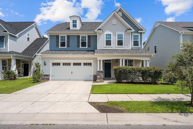 craftsman inspired home with a garage and a front yard