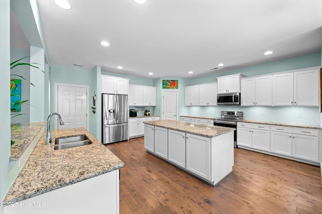 kitchen with sink, white cabinets, and appliances with stainless steel finishes