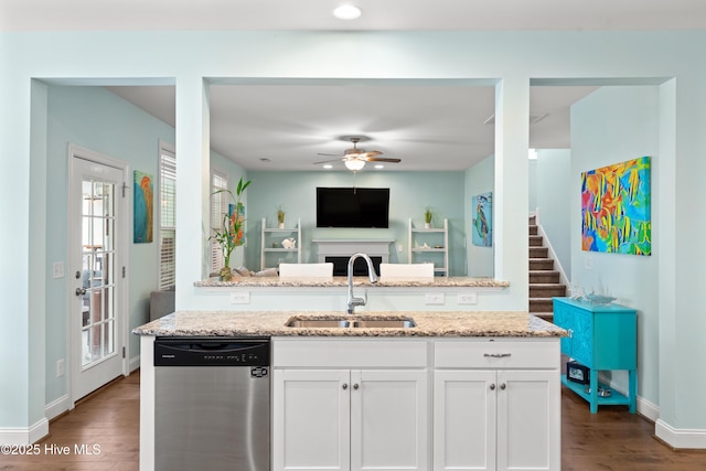 kitchen featuring white cabinetry, dishwasher, sink, and light stone counters