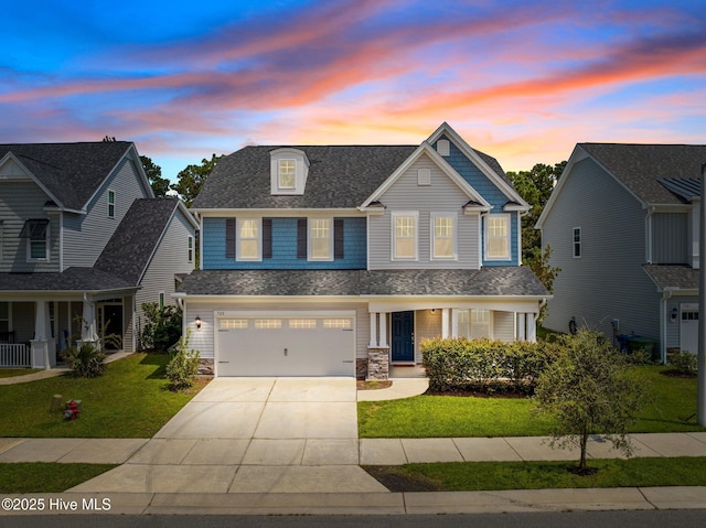 view of front of house with a yard and a garage