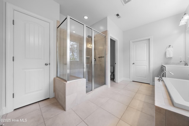 full bathroom featuring independent shower and bath, vanity, tile patterned flooring, and toilet