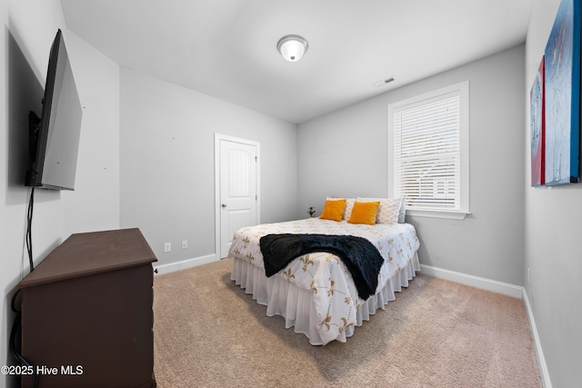 bedroom with light colored carpet