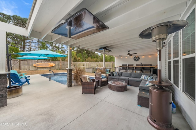 view of patio with an outdoor living space with a fire pit and ceiling fan