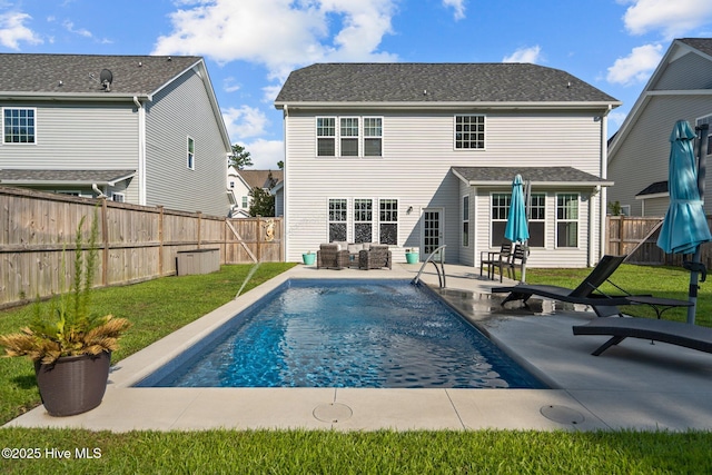 rear view of house with a yard, outdoor lounge area, and a patio