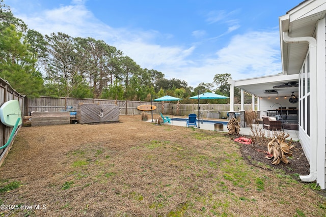 view of yard featuring a fenced in pool, an outdoor living space, a patio area, and ceiling fan