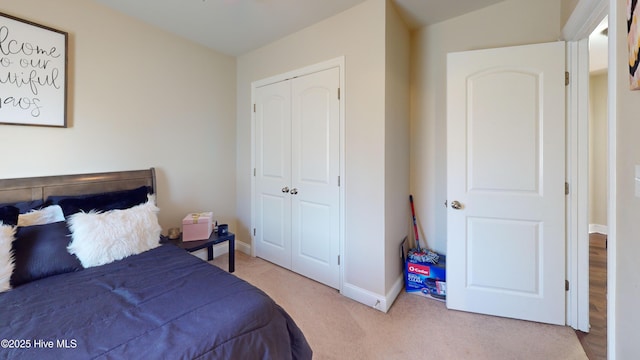 bedroom featuring a closet and light carpet