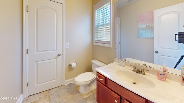 bathroom featuring toilet and vanity