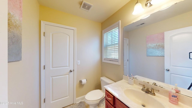 bathroom with toilet and vanity