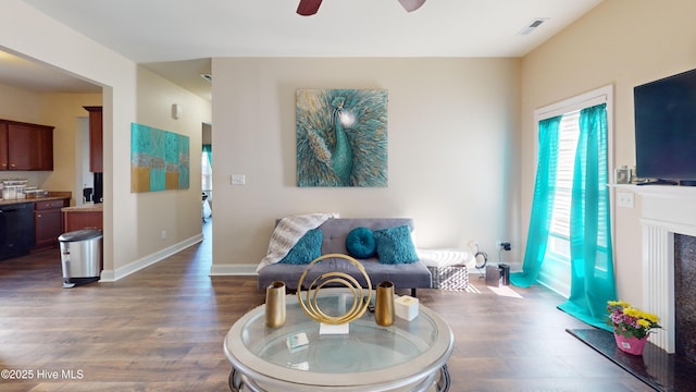 sitting room featuring dark hardwood / wood-style floors and ceiling fan