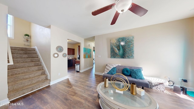 living room with dark wood-type flooring and ceiling fan