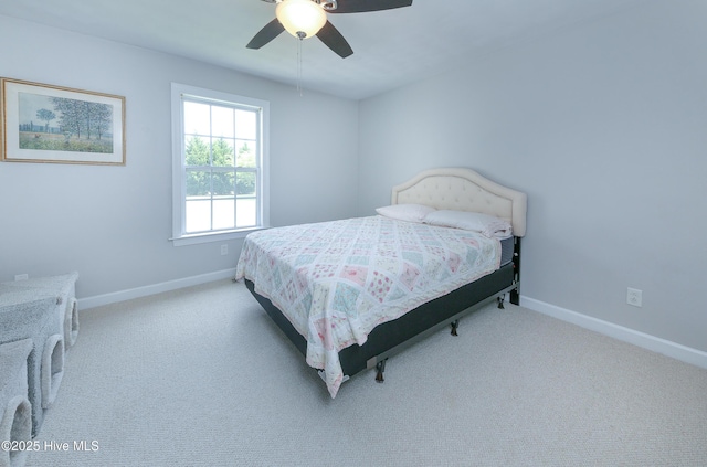 bedroom with light carpet and ceiling fan