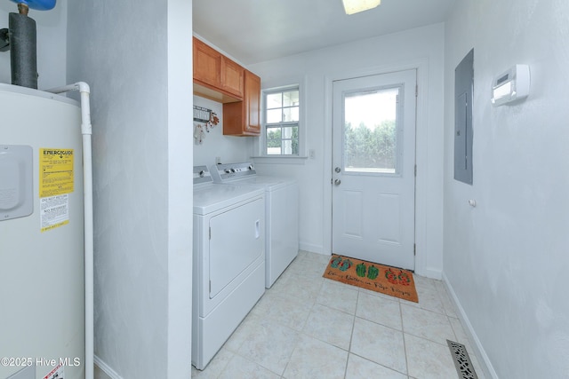 laundry area with cabinets, light tile patterned floors, electric panel, washer and clothes dryer, and water heater