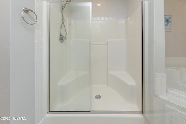 bathroom featuring a shower with door