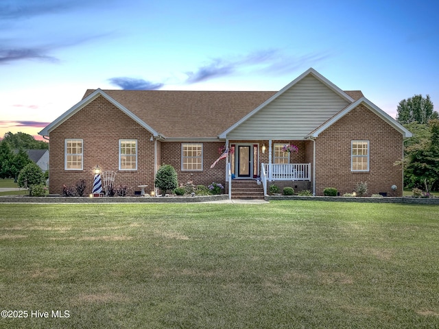 ranch-style home featuring a lawn and a porch