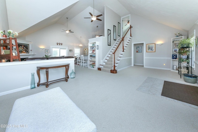 carpeted living room with high vaulted ceiling