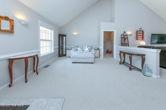 carpeted living room featuring high vaulted ceiling