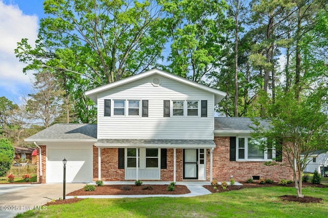 split level home with a garage, brick siding, a front lawn, and concrete driveway