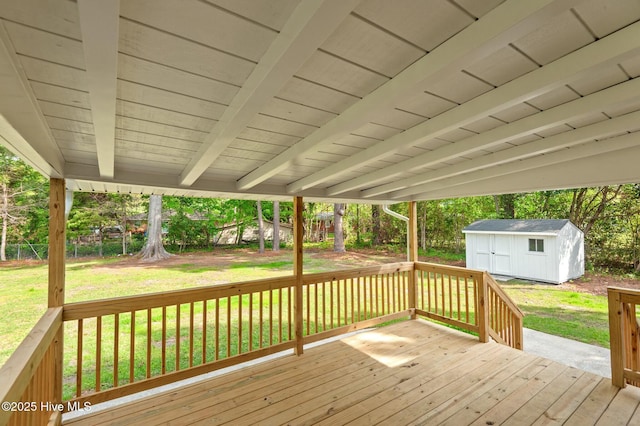 deck featuring a storage shed, an outbuilding, and a lawn