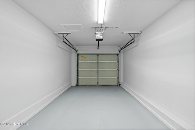 garage with baseboards and a garage door opener