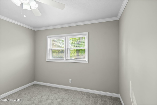 empty room featuring crown molding, baseboards, and carpet