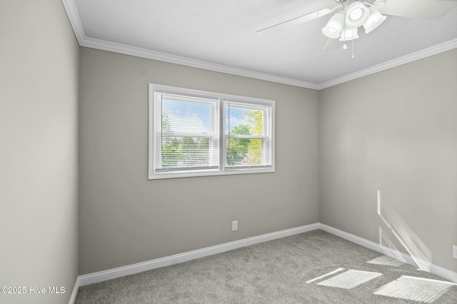 carpeted empty room with baseboards, crown molding, and ceiling fan