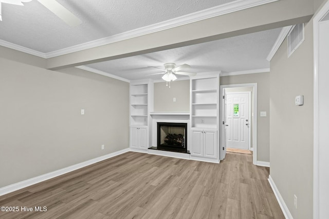 unfurnished living room with baseboards, a fireplace with raised hearth, ceiling fan, light wood-style floors, and a textured ceiling