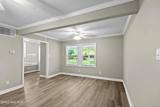 spare room featuring visible vents, a textured ceiling, wood finished floors, and ceiling fan