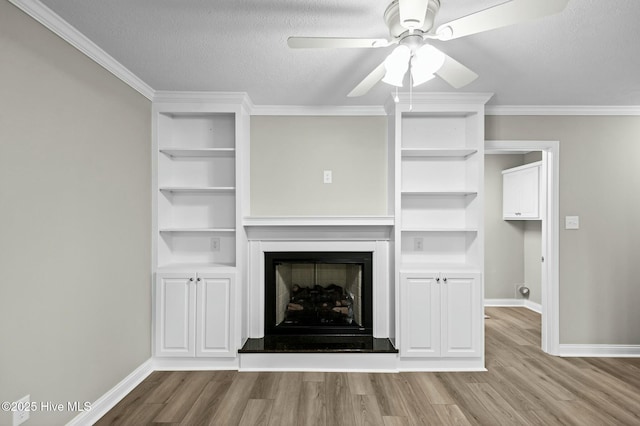 unfurnished living room with baseboards, a ceiling fan, and wood finished floors