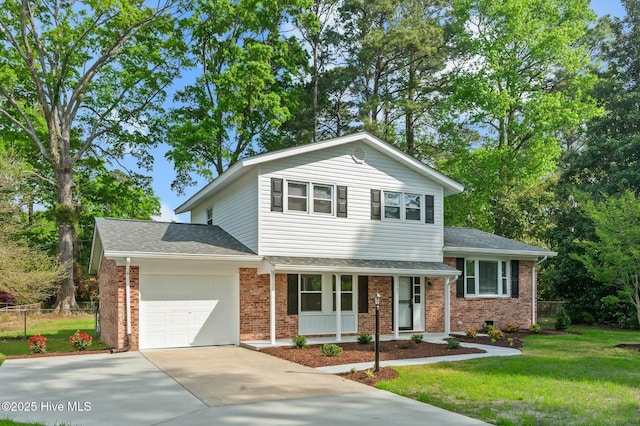 split level home featuring a front yard, an attached garage, fence, concrete driveway, and brick siding
