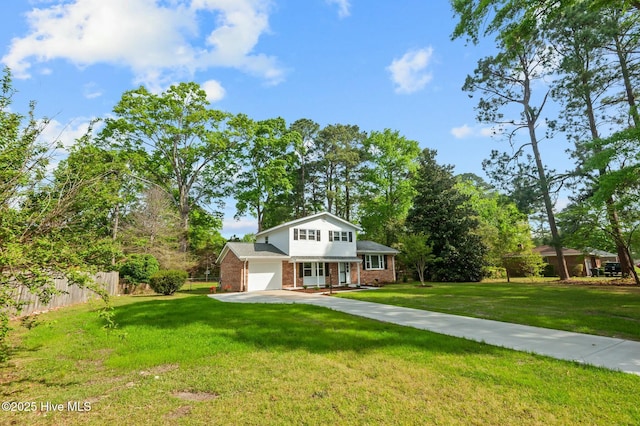 view of front of home with brick siding, a front lawn, fence, and concrete driveway