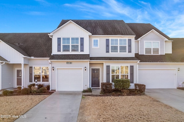 view of front of house featuring a garage, driveway, and a shingled roof