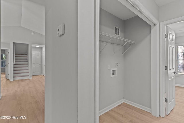 laundry room with washer hookup and light hardwood / wood-style floors