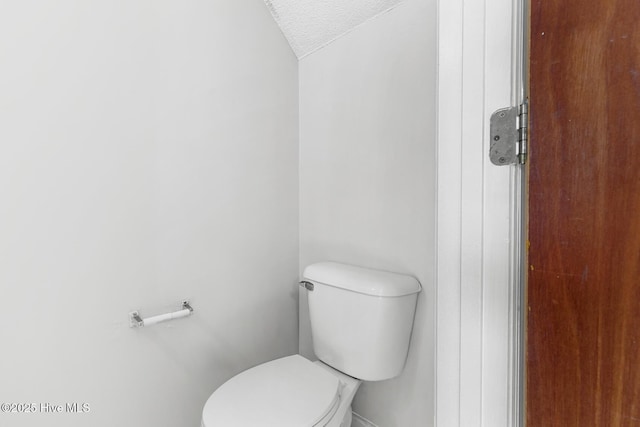 bathroom featuring a textured ceiling and toilet