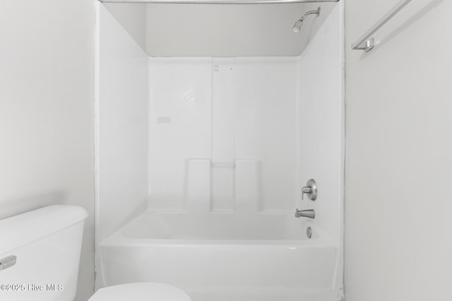 bathroom with shower / washtub combination and toilet