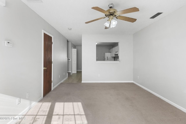 empty room with light colored carpet and ceiling fan