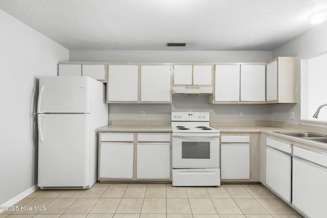 kitchen featuring sink, white appliances, light tile patterned floors, white cabinetry, and a textured ceiling