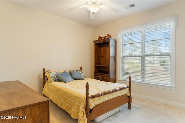 bedroom with ceiling fan and light carpet