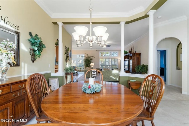 tiled dining area with an inviting chandelier, ornamental molding, and decorative columns