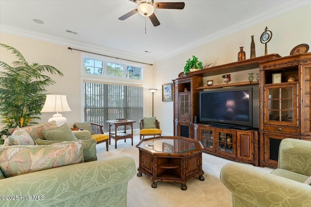 carpeted living room featuring crown molding and ceiling fan