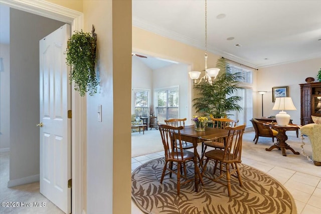 dining space with light tile patterned floors, crown molding, and a notable chandelier