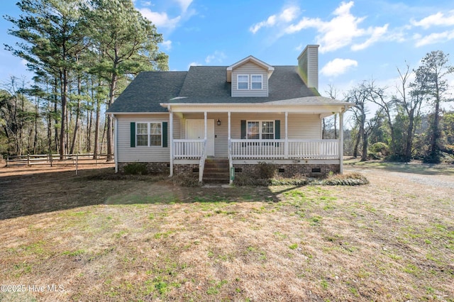 view of front of house featuring covered porch and a front lawn