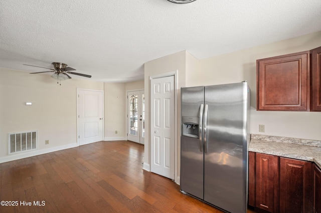 kitchen with ceiling fan, dark hardwood / wood-style floors, stainless steel fridge with ice dispenser, and a textured ceiling