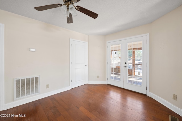 unfurnished room featuring french doors, ceiling fan, dark hardwood / wood-style floors, and a textured ceiling