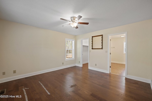 spare room featuring a textured ceiling, dark hardwood / wood-style floors, and ceiling fan