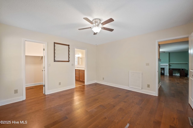 empty room with dark hardwood / wood-style flooring and ceiling fan