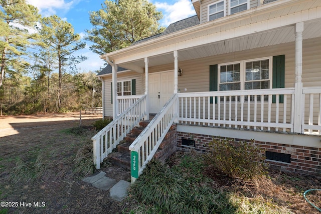 entrance to property featuring covered porch