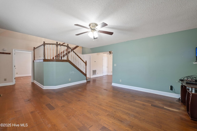 unfurnished living room featuring hardwood / wood-style flooring, a textured ceiling, and ceiling fan